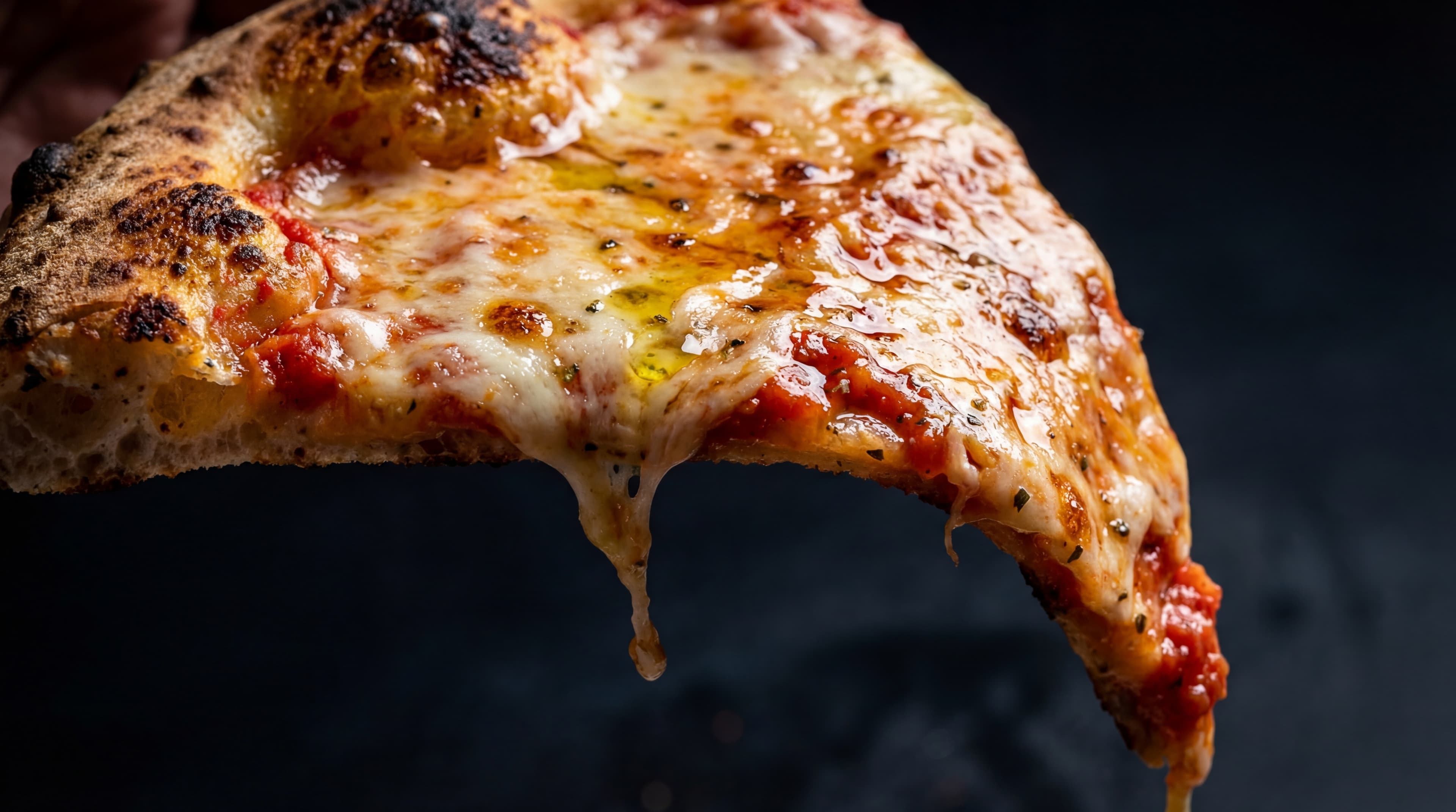 New York style pizza slice with stretchy melted mozzarella